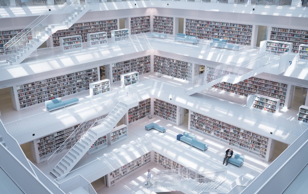 Minimalist white cube interior of Stadtbibliothek Stuttgart with tiered galleries